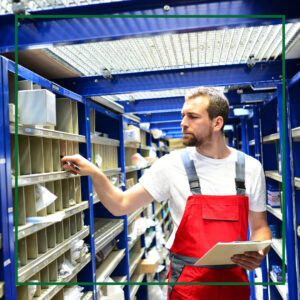  Car technician performing inventory on car parts. 